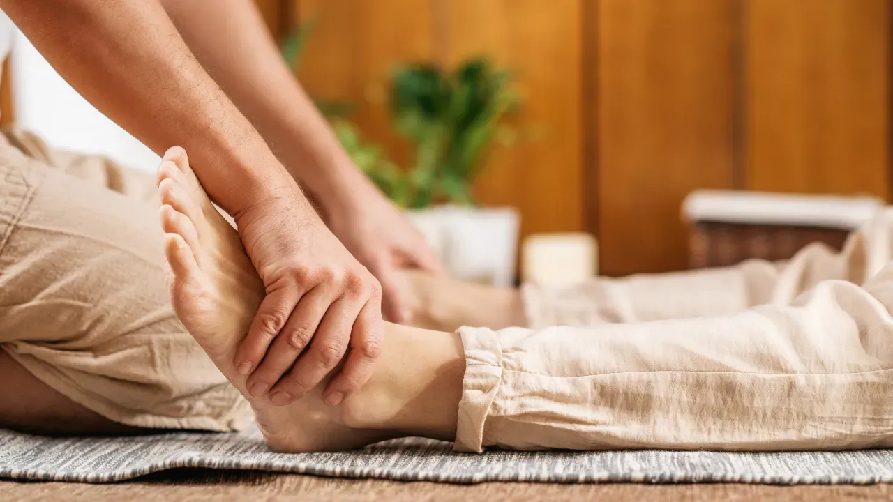 Assisted leg stretch illustrating the Thai stage of the relaxation package