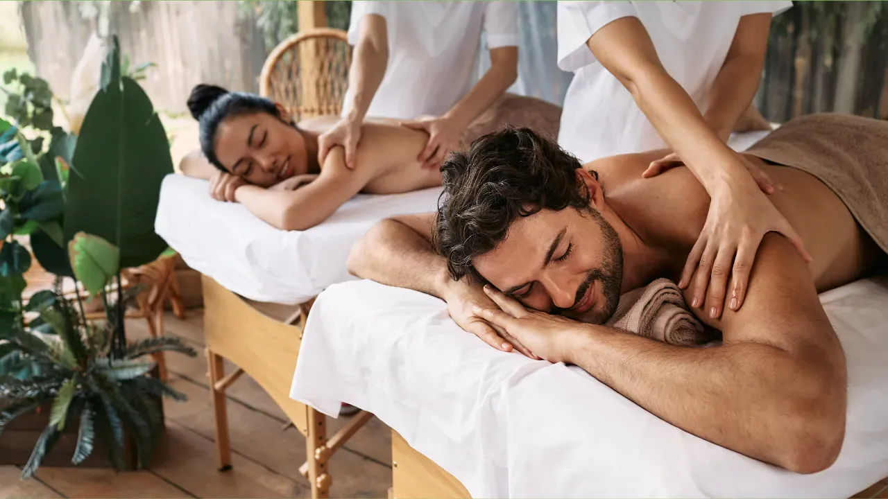 Two guests receiving a couples massage side by side
